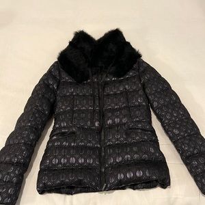 Black Moncler puffer jacket with detachable fur collar.